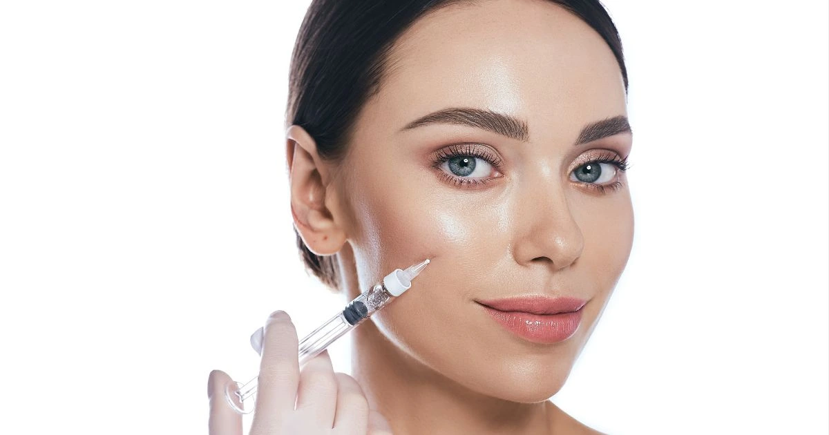 Licensed female provider showing a tablet to an older client, discussing a customized dermal filler treatment plan in Scottsdale.