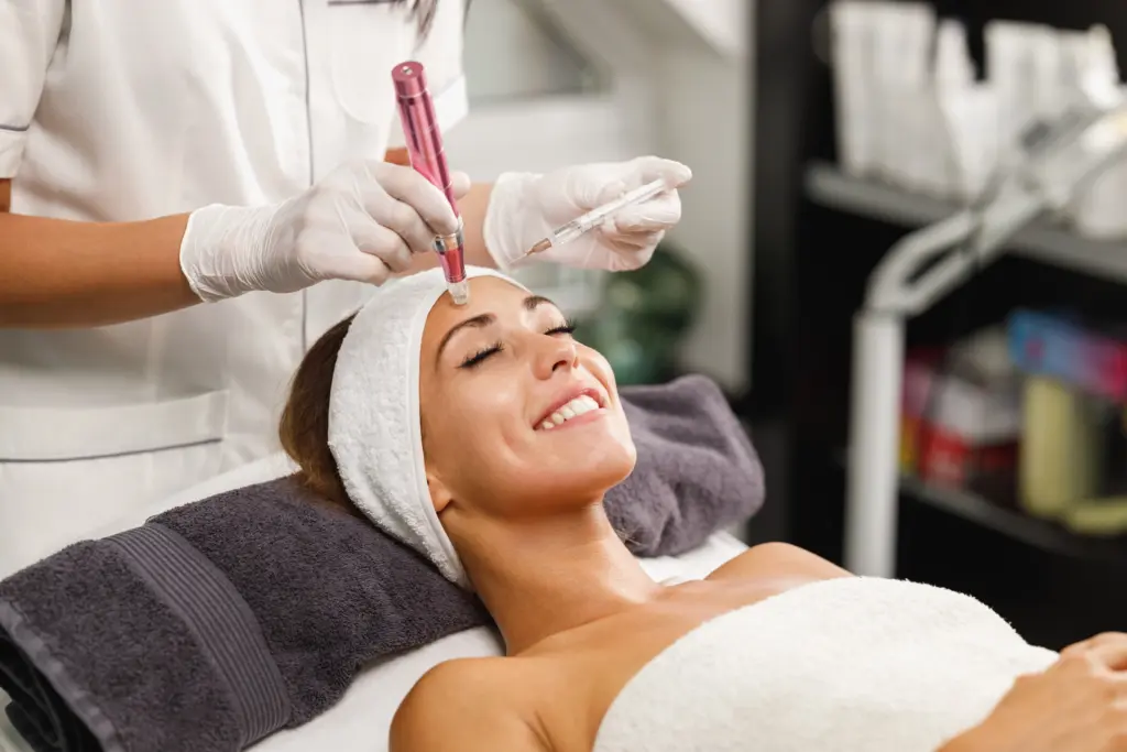 Woman receiving microneedling facial treatment with a dermapen device at Skindale Medspa in Scottsdale, AZ.